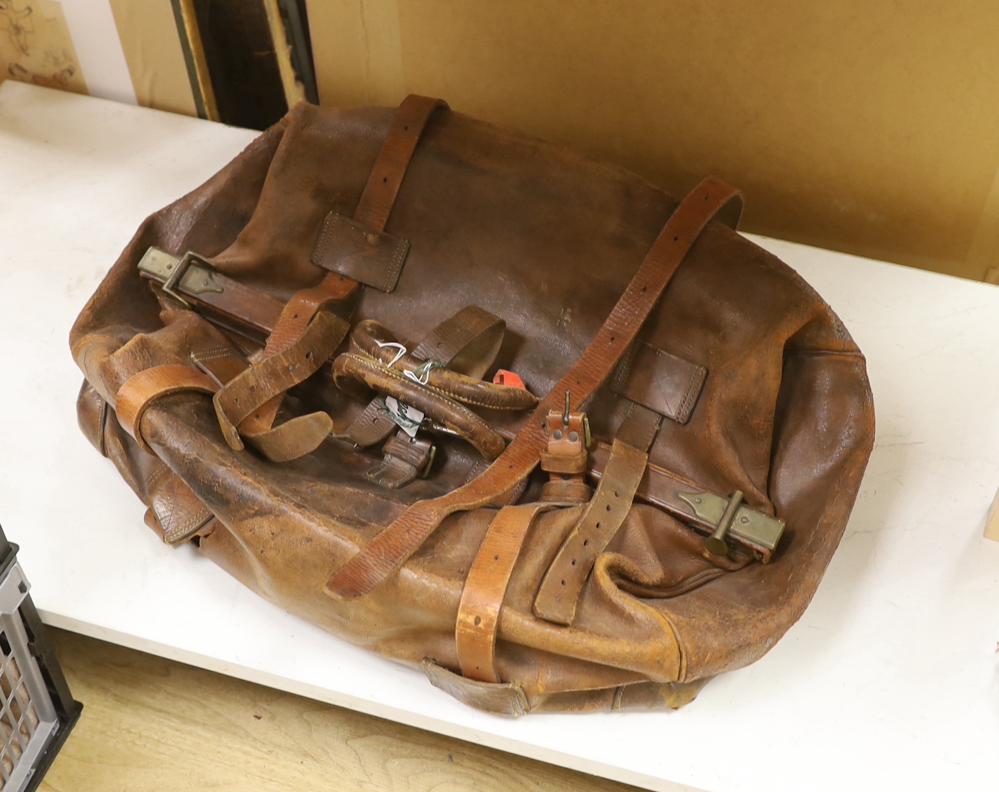 A late 19th early 20th century large brown leather Gladstone bag with leather straps, top frame 62cm wide